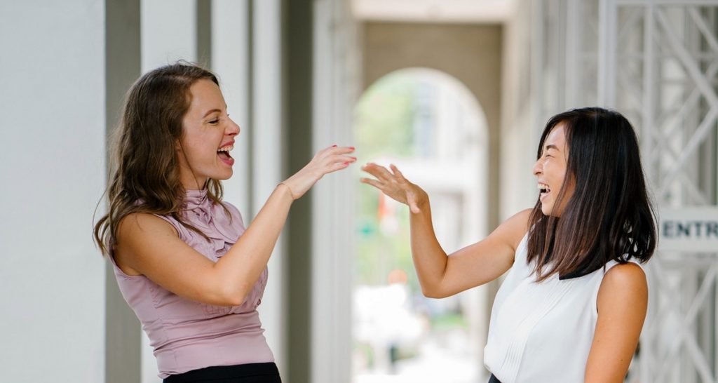 two girls laughing