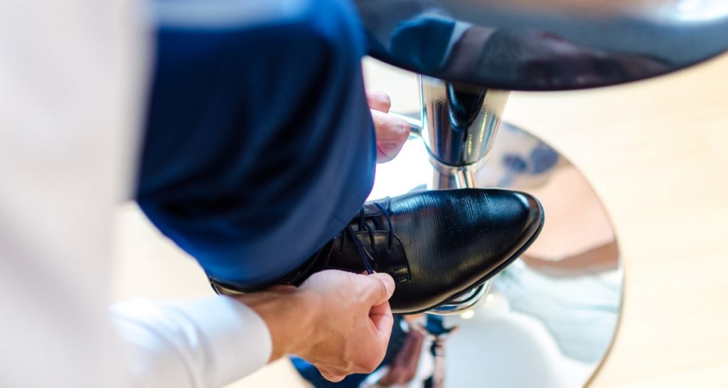 man wearing blue pants and black shoes