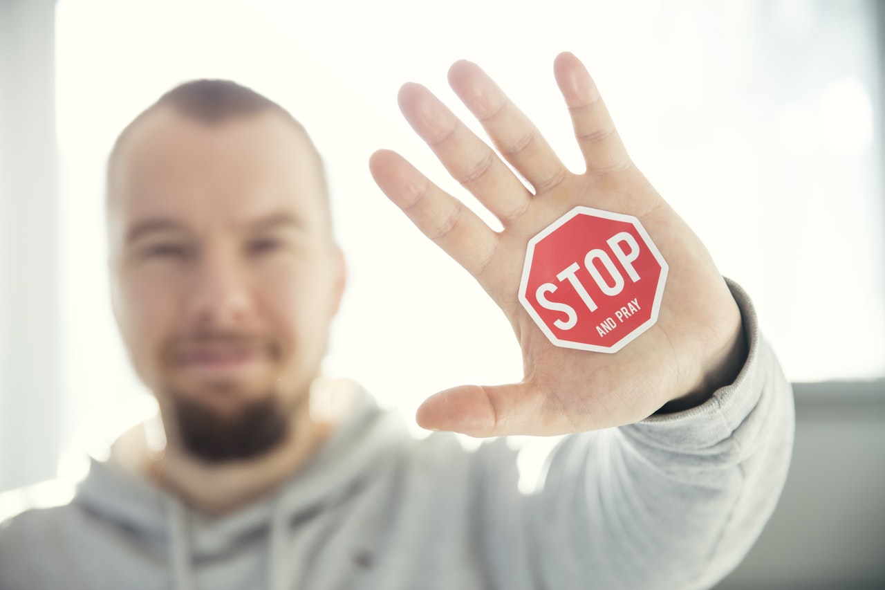 stop sign on a man's palm