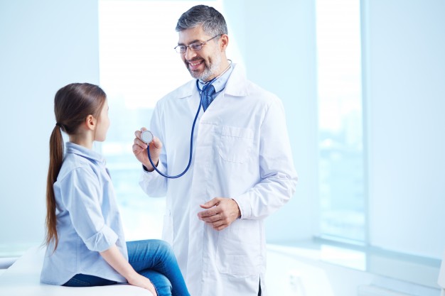doctor examining his young patient